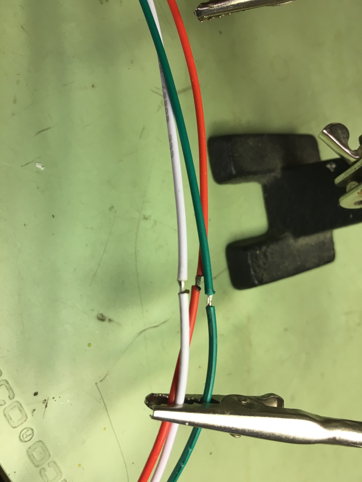 Close-up of stripped wires in alligator clips